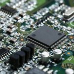 closeup of electronic circuit board with cpu microchip electronic components background scaled